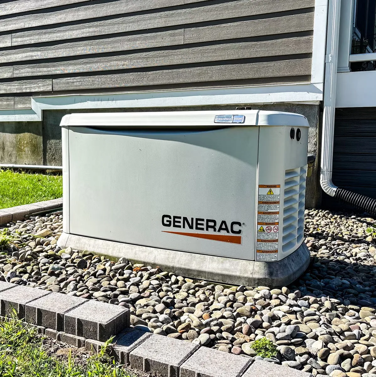 Generac standby generator installed on a pad beside a home by 352 Electric in Gainesville, FL